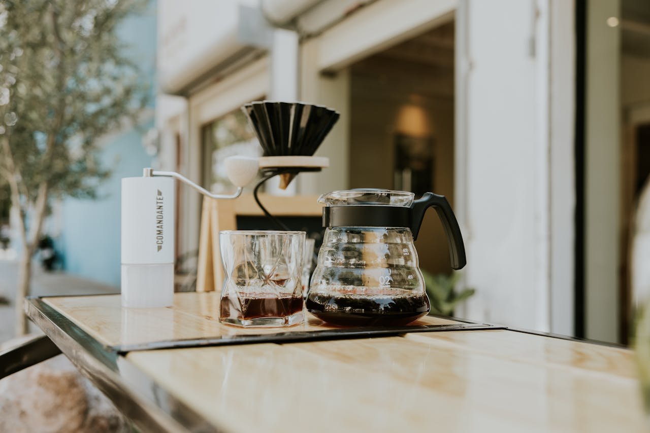 The Art of Drawing Readers In: Your attractive post title goes here A stylish outdoor café setup with coffee accessories on a wooden table.